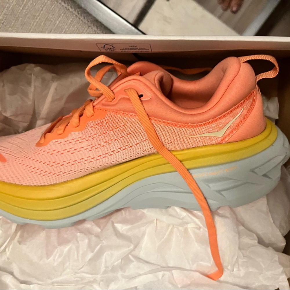 Hoka One One W Bondi 8 in coral peach colorway.
